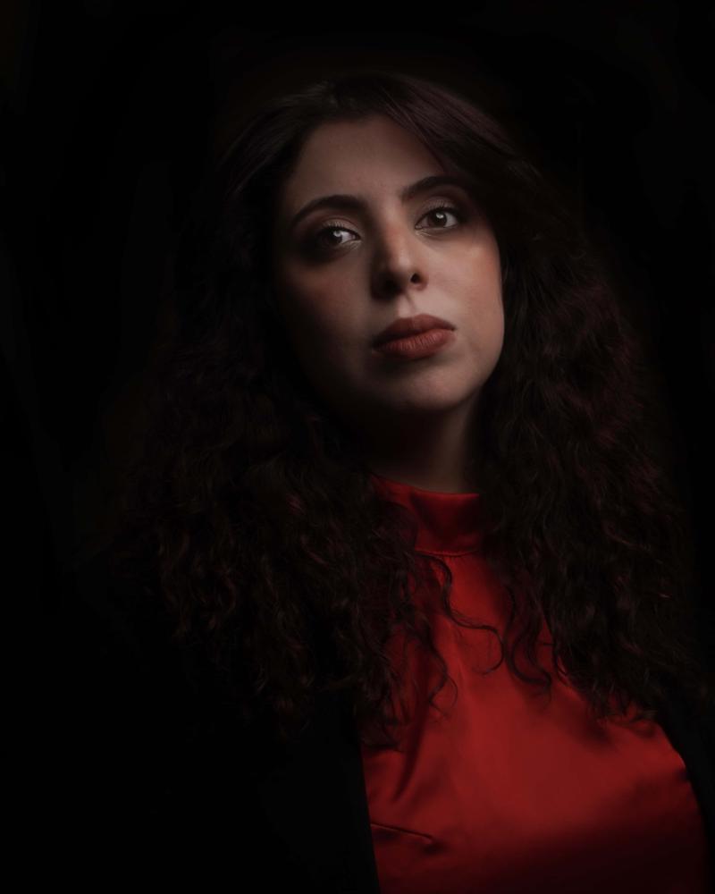 Sol Risé — Photo Book portrait in red satin top with chiaroscuro lighting